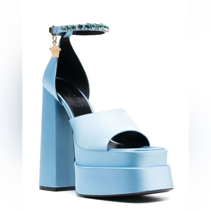 Item Info Silk-Blend Satin Heeled Sandals In Blue. Signature Medusa Charm And Crystal-Cut Accents At Adjustable Pin-Buckle Ankle Strap. Open Square Toe Logo Embossed At Buffed Leather Footbed Covered Platform Midsole Covered Block Heel With Rubber Injection Signature Medusa Hardware At Polished Calfskin Outsole Platform: H2.5 In Heel: H6 In Supplier Color: Ice Blue Upper: Textile, Goatskin, Lambskin. Sole: Calfskin. Made In Italy. Chic Light Blue Sandals For Evening, Blue Open Toe Sandals For Gala, Light Blue Ankle Strap Sandals For Evening, Blue Ankle Strap Sandals For Evening, Light Blue Evening Sandals With Wrapped Heel, Blue Ankle Strap Sandals For Gala, Blue High Heel Sandals For Gala, Luxury Blue Open Toe Sandals, Designer Blue Platform Sandals