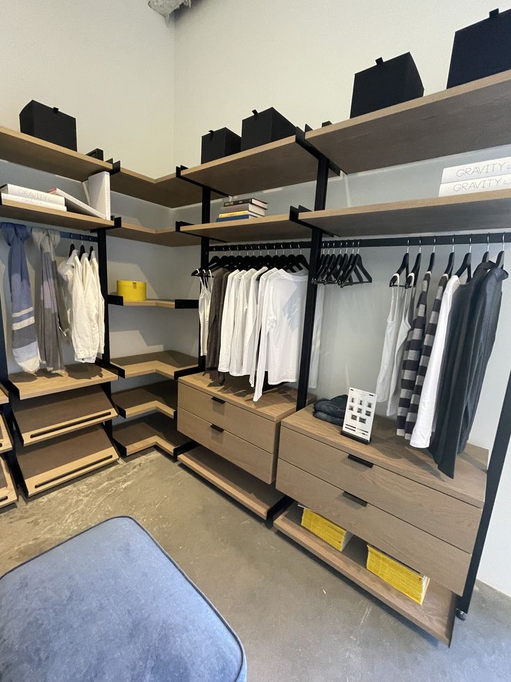 an organized closet with drawers and clothes on shelves