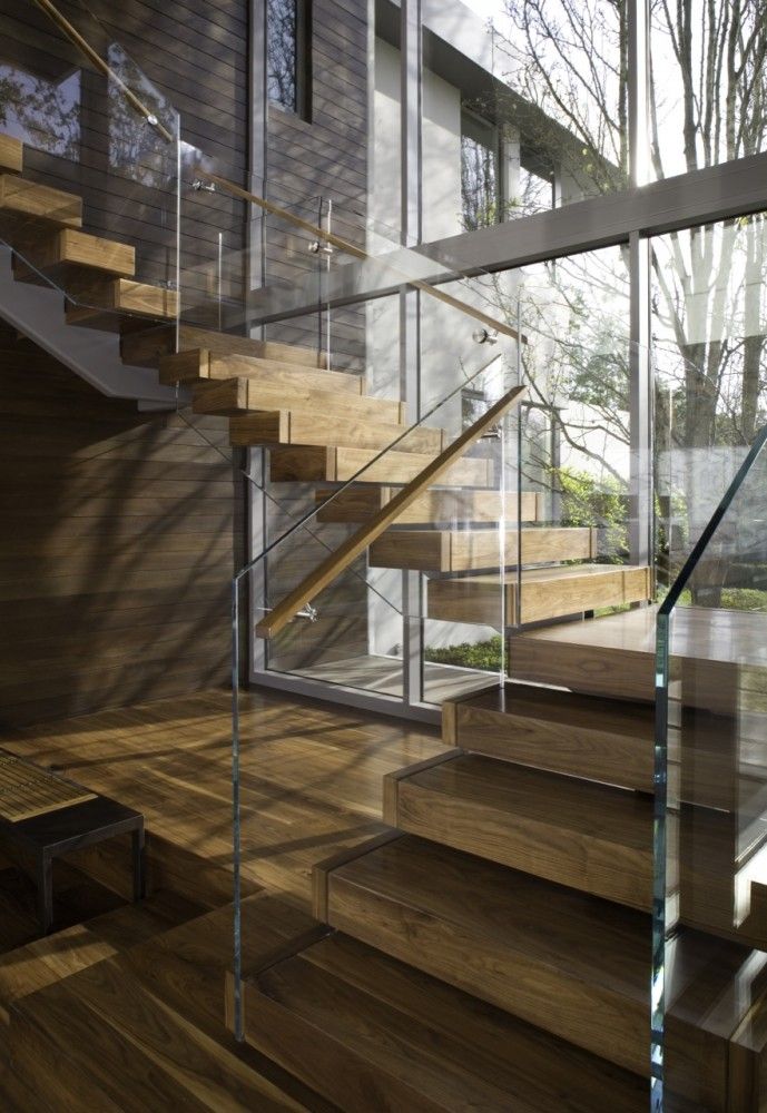 the stairs are made of glass and wood