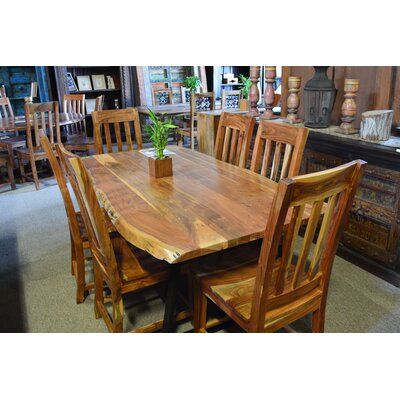 a wooden table and chairs in a store