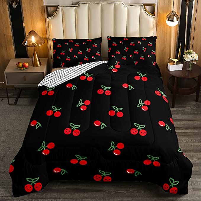 a black bed with cherries on it