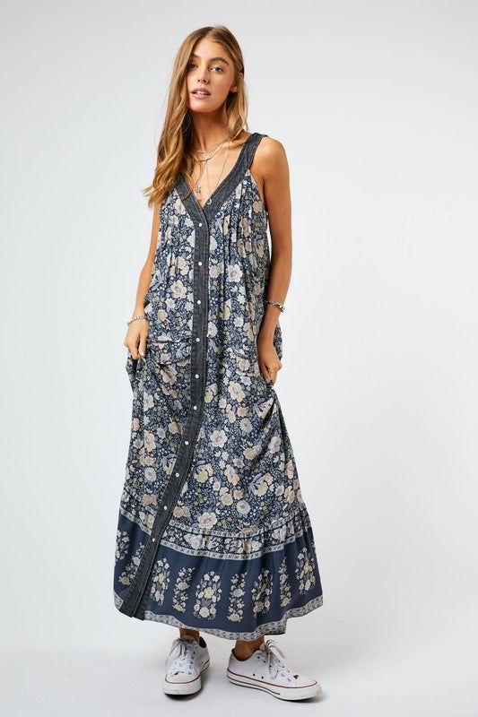 Step away from the same-old and go for something new this season. Show your wild and romantic side in this beautiful floral maxi dress. With a v-neck and button front detail, this dress is easy to wear and has side pockets for a practical edge. The relaxed fit will keep you comfortable during long days and nights. With this sophisticated and timeless piece, your fashion-forward wardrobe will speak volumes. Self: 100% RayonContrast: 80% Cotton, 20% PolyesterLining: 100% Polyester Want to view thi Flowy V-neck Maxi Dress With Buttons, Casual V-neck Maxi Dress With Ditsy Floral Print, Flowy Spring Maxi Dress With Button Closure, Maxi Dress With Ditsy Floral Print For Day Out, Ditsy Floral Print Maxi Dress For Day Out, V-neck Sundress With Ditsy Floral Print, Bohemian V-neck Dress With Buttons, Bohemian Summer Dresses With Button Closure, Bohemian Summer Maxi Dress With Buttons