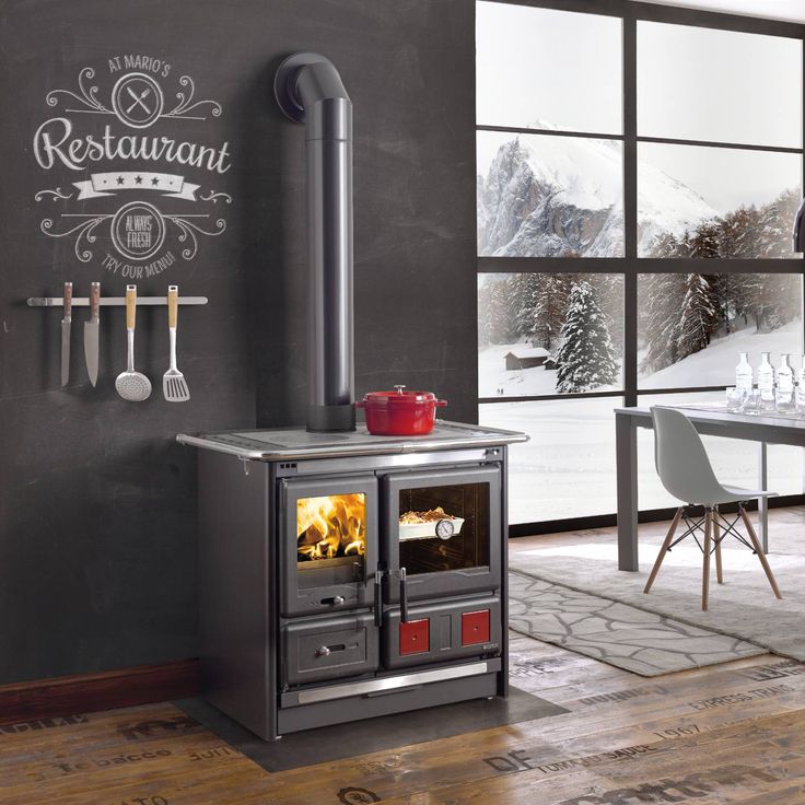 an old fashioned stove in the middle of a room