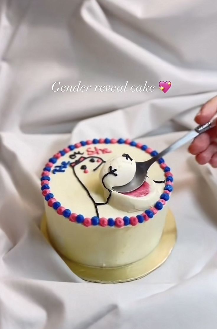 a person cutting into a cake with a knife