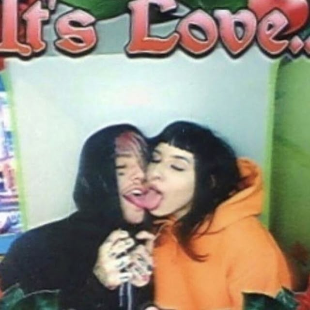 two women are kissing each other in front of an advertisement for it's love