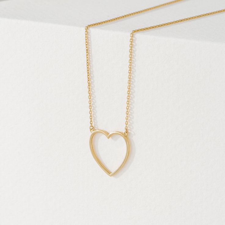 Anabella Follow your heart and it’ll lead you to our 14k gold necklaces. Add a touch of timeless elegance with our delicate Heart Cut-Out Pendant in Solid Gold. This beautiful pendant features a classic heart shape with a modern open center design. Crafted from 14k solid gold (available in yellow, white, or rose gold), this pendant offers long-lasting quality and a luxurious shine. Its versatility makes it perfect for any outfit, and it's a thoughtful gift symbolizing love and affection. - Handm Heart Cut Out, 14k Gold Necklace, Follow Your Heart, Gold Necklaces, White Gift Boxes, Gold Set, Perfect Gift For Her, Diamond Cut, Cable Chain