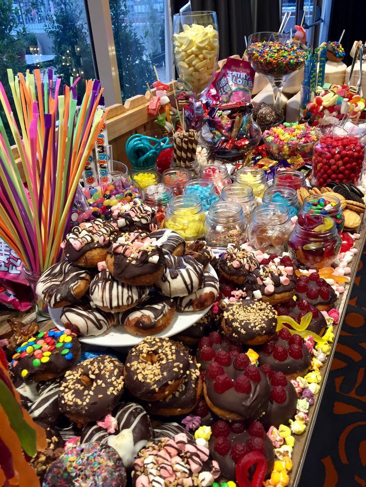 a table filled with lots of donuts and candy