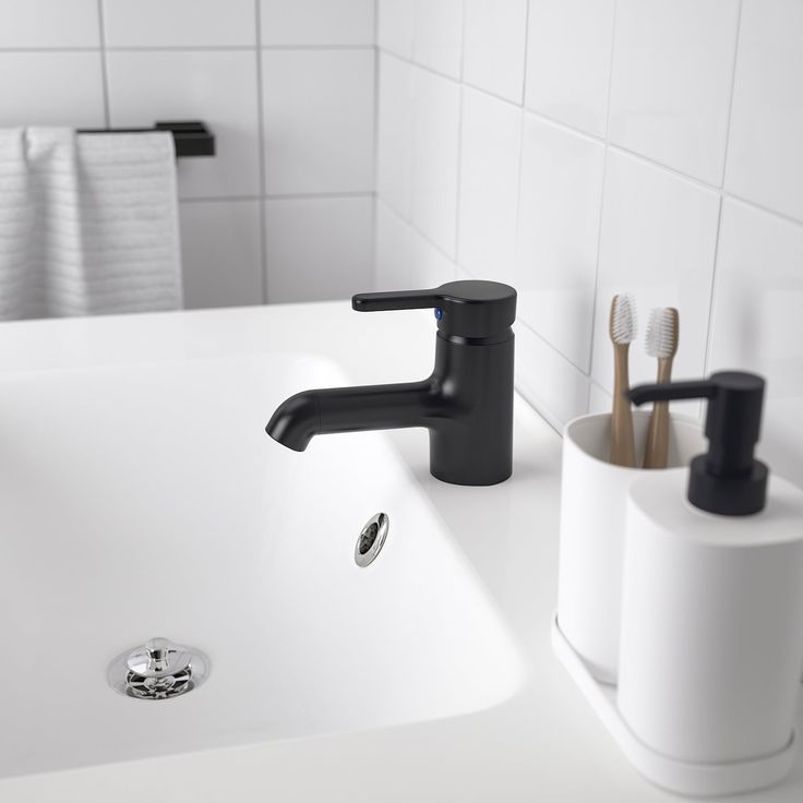 two toothbrushes sitting on the edge of a bathroom sink