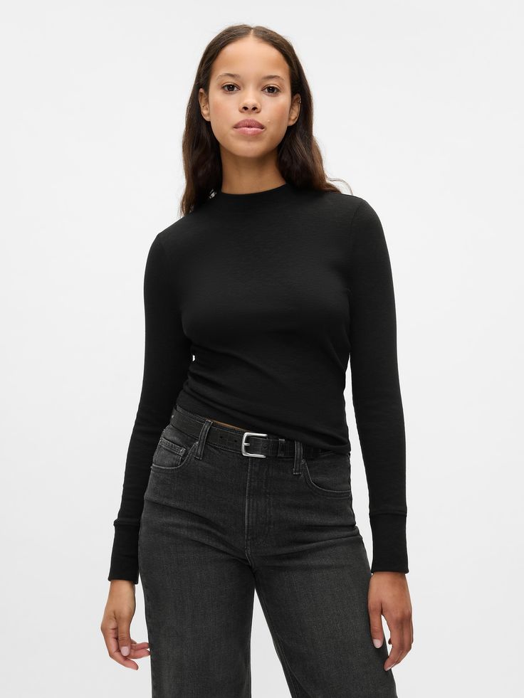 Soft cotton-blend, ribbed knit T-shirt.  Mini mockneck.  Long sleeves.  Fit: Stretch-to-Fit.  Slim & stretchy that forms to your shape.  Hits at the hip.  Models wearing Gap Black Long Sleeve Tee, Fitted Long Sleeve Shirt Outfits, Fitted Black Versatile T-shirt, Black Relaxed Fit Ribbed T-shirt, Black Ribbed Long Sleeve T-shirt, Black Tshirt Outfit, 90s Black Stretch T-shirt, Black Stretch T-shirt With Ribbed Neckline, Long Sleeve Shirt Outfits