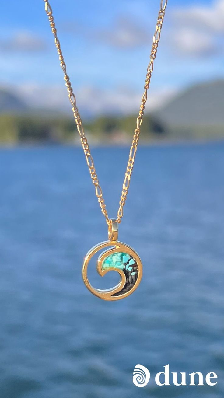 Keep the shore close always with our simply elegant Wave Necklace featuring our Gradient Technique with Turquoise Power Stone. This piece is handcrafted with your choice of sand or natural element, layered to a gem-like finish. It’s the perfect everyday reminder of your favorite beach travels. Personalize your design with your favorite beach or send in your own element! Ocean-inspired Yellow Gold Jewelry, 14k Gold Turquoise Birthstone Necklace, Nickel Free Ocean-inspired Pendant Jewelry, Ocean-inspired 14k Gold Jewelry, 14k Gold Jewelry With Natural Stones, Nickel-free Ocean-inspired Pendant Jewelry, Ocean-inspired Turquoise Pendant Necklace, Blue Gemstone Jewelry For The Beach, Turquoise 14k Gold Round Pendant Jewelry