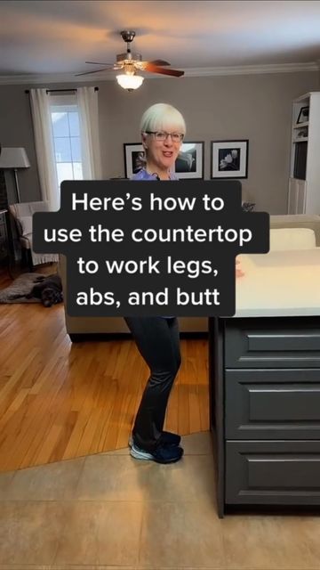 a woman standing in front of a counter with a sign on it that says here's how to use the countertop to work legs, abss, and butts,