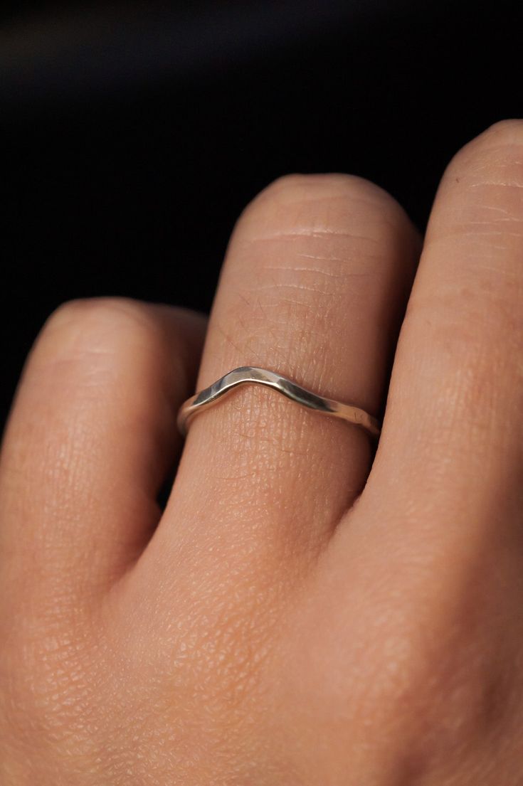 A curved arc stacking ring made from Sterling Silver Metal. After countless requests and some fine tuning, we finally perfected this ring shape! The Teardrop Ring stacks with all of our rings beautifully. It adds dimension to any stacking rings you wear daily but it also makes the perfect, low-key wedding band! The bend in the Teardrop Ring curves to hug a set stone beautifully if you are looking for a complimentary piece for your existing engagement ring. This listing is for ONE SINGLE RING.Made from solid STERLING SILVER metal.Available in a SMOOTH or HAMMERED texture. The smooth finish is fully round metal.Each ring measures approximately 1.75 mm in width. We recommend stacking the Teardrop Ring with the Pebble Ring, one of our favorite dimensional pieces inspired by precious stone ring Minimalist 14k Gold Teardrop Ring, Minimalist Teardrop Stackable Jewelry, Minimalist Curved Wedding Rings, Minimalist Sterling Silver Teardrop Rings, Minimalist Teardrop Ring For Everyday, Hand Forged Stackable Rings For Anniversary, Silver Teardrop Stackable Rings, Silver Stackable Teardrop Rings, Teardrop Stackable Adjustable Rings