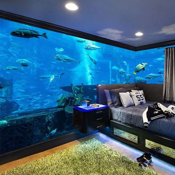 a bed room with a large aquarium wall