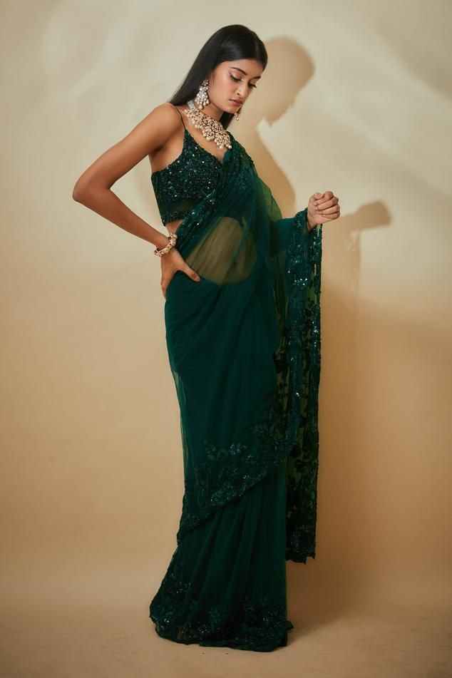 Green saree with sequins hand embroidered borders. Comes with a blouse and an underskirt.
Components: 3
Pattern: Hand embroidered
Type Of Work: Sequins
Neckline: Leaf Neck
Sleeve Type: Sleeveless
Fabric: Tulle , Buttercrepe
Color: Green
Other Details: 
Heavily embroidered blouse
Occasion: Wedding - Aza Fashions At Restaurant, Green Tulle, Border Saree, Green Saree, Net Saree, Birthday Surprise Party, Blouse For Women, Fashion App, Saree With Blouse