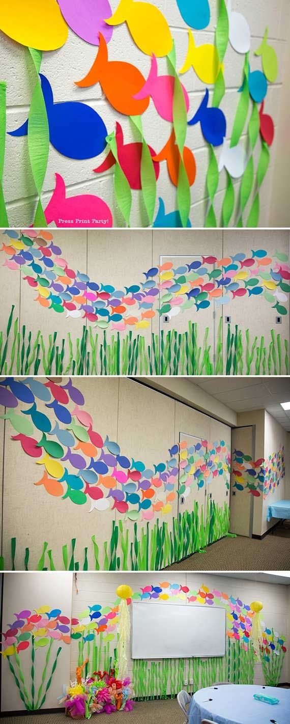 some paper fish are hanging on the wall in this classroom decorationating project for children's rooms