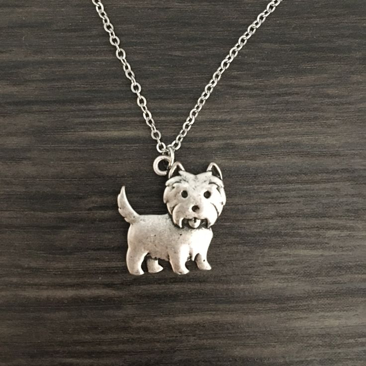 Accent your everyday outfits with this playful Westie necklace and display your favorite pooch! Hanging from a silver tone chain, this Westie pendant works well with an array of necklines for true versatility in your jewelry wardrobe. Paw-some for everyday wear, it consolidates your image as a dog person by adding a fun dog inspired finishing touch to casual and formal ensembles alike. Pick it for yourself or as a thoughtful gift for a dog lover - its subtle style and playful design bring a love Cute Nickel-free Sterling Silver Necklaces, Cute Hypoallergenic Silver Charm Necklaces, Cute Silver Charm Necklaces For Everyday, Sterling Silver Dog Tag Necklace With Charms, Cute Silver Hypoallergenic Necklace, Cute Silver Necklace With Lobster Clasp, Cute Hypoallergenic Sterling Silver Necklaces, Cute Hypoallergenic Sterling Silver Necklace, Nickel Free Silver Dog Tag Necklace