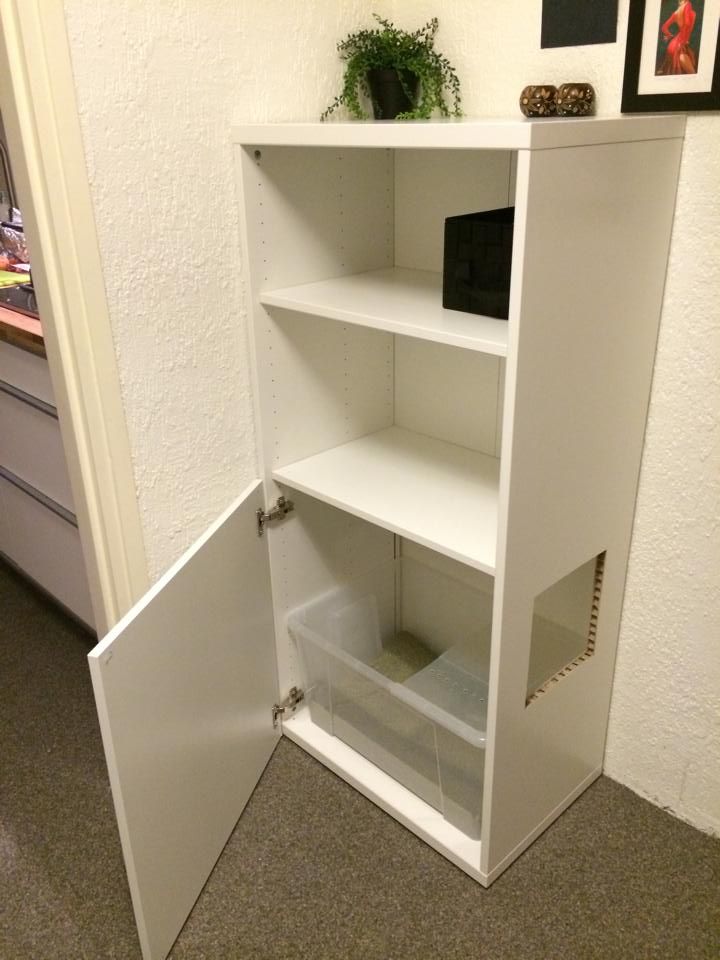 an open book shelf in the corner of a room