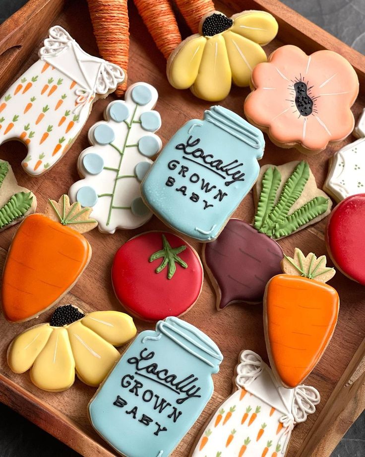 decorated cookies in the shape of carrots, radishes, and mason jars