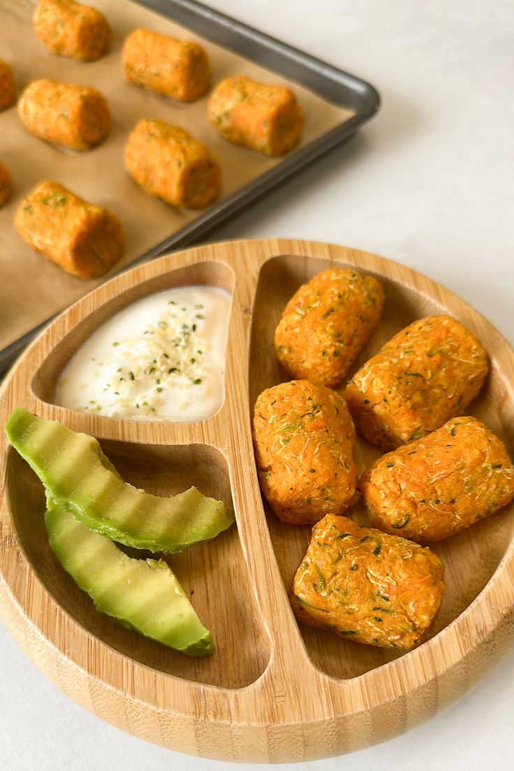 a wooden bowl filled with food next to a muffin tin