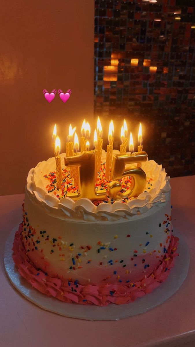 a birthday cake with lit candles on top of it and the number five in the middle