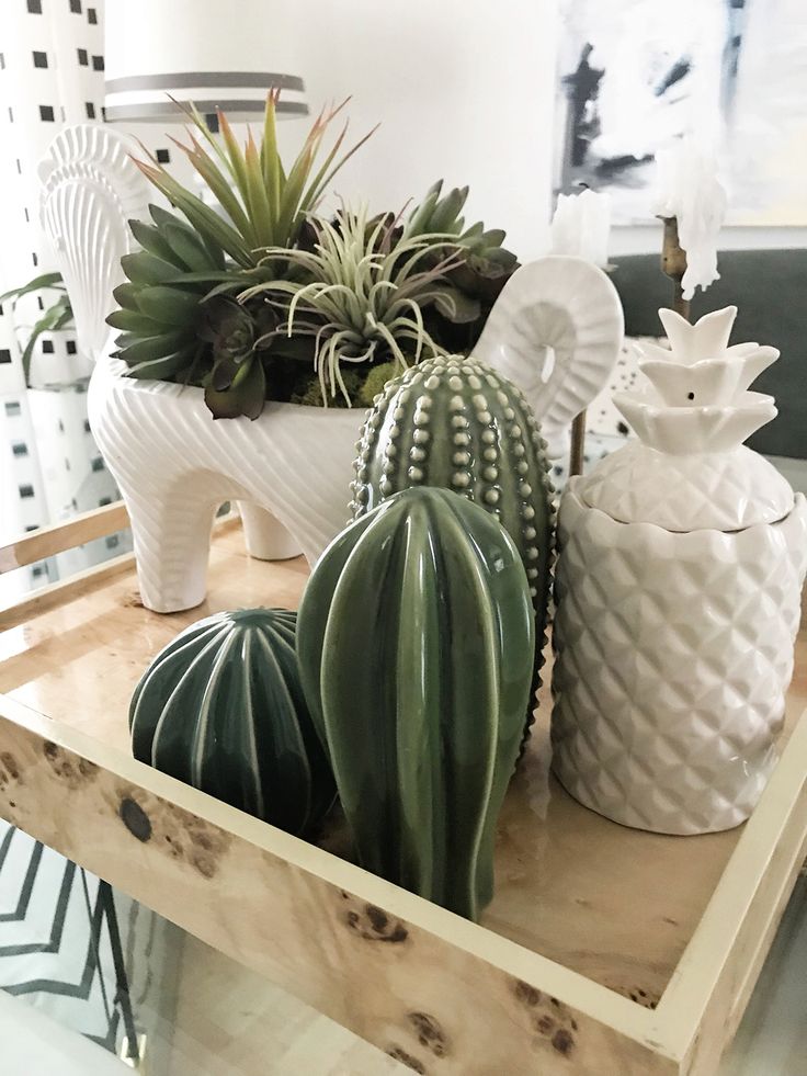 some plants are sitting on a wooden tray