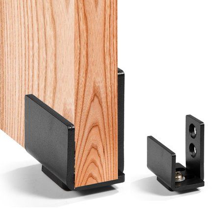 a pair of black brackets are attached to the side of a wooden door