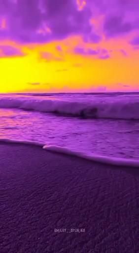 a purple and yellow sunset over the ocean