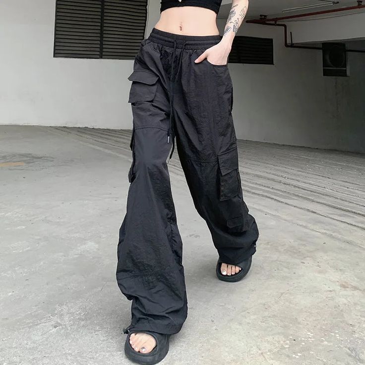 Get ready to elevate your street style with our High Waisted Utility Joggers. These joggers feature a trendy high waist and practical utility pockets, perfect for carrying all your essentials. Pair with your favorite sneakers for a comfortable and stylish look. (But don't worry, you won't actually have to jog in them.) Baggy High Waist Sporty Joggers, High-waist Techwear Cargo Pants For Streetwear, High Waist Techwear Cargo Pants For Streetwear, Wide Leg Cargo Pants With Side Pockets For Sports, Trendy Relaxed Fit Cargo Style Sweatpants, Trendy Relaxed Fit Cargo Sweatpants, Trendy Wide Leg Sweatpants For Streetwear, Techwear Cargo Style Joggers For Outdoor, Trendy Streetwear Bottoms With Side Pockets