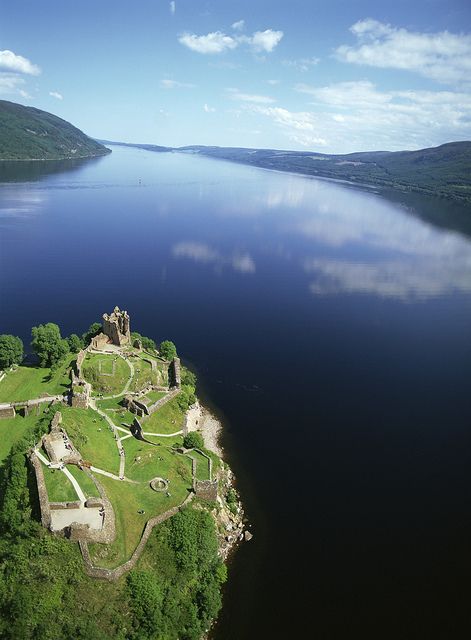 an aerial view of a castle in the middle of a lake