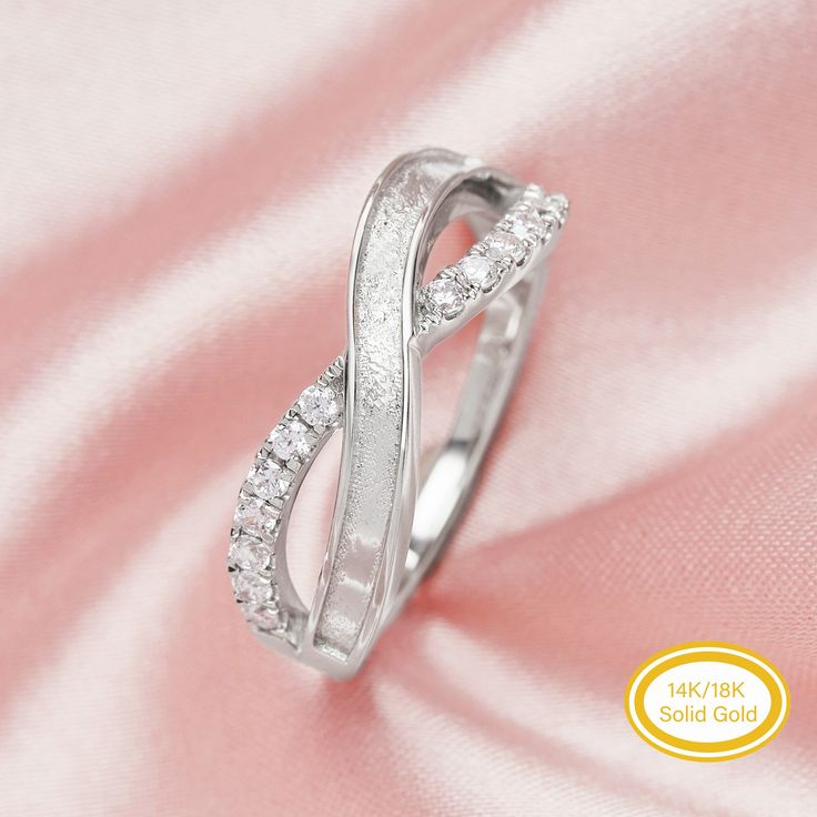 a white gold diamond ring on a pink satin background with the words blkk jewelry