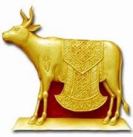 a golden cow statue on top of a red base with an intricately designed coat of arms