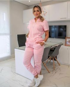 a woman in pink is standing on the counter next to a desk and chair with a television