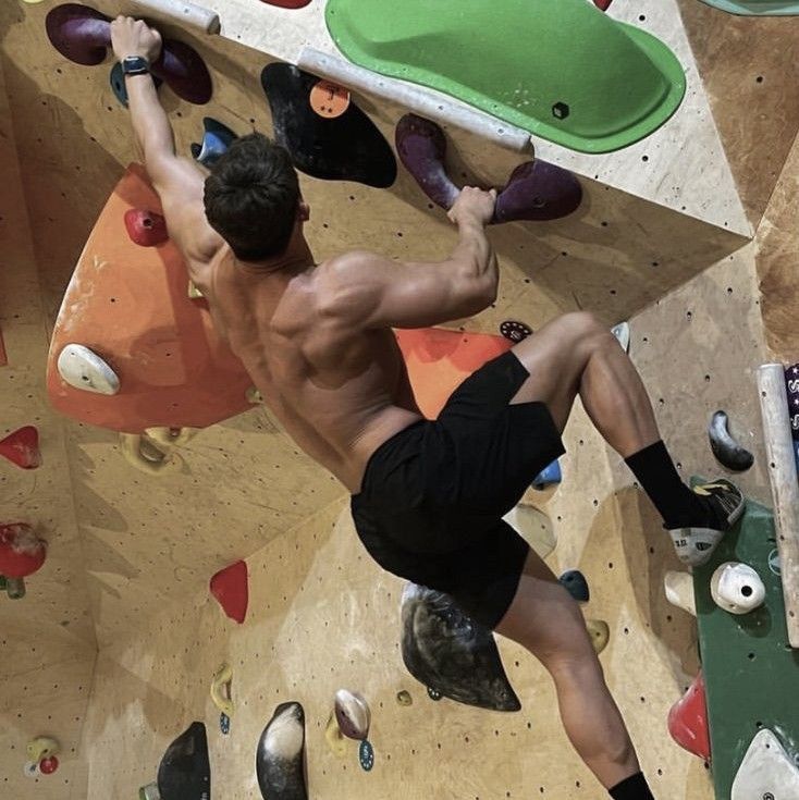 a man climbing up the side of a rock wall