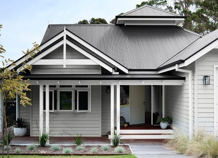 a grey house with white trim and gray roof