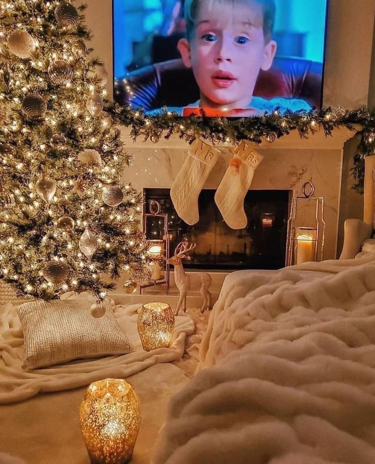 a living room with a christmas tree in the corner and a flat screen tv on