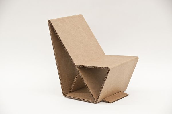 a chair made out of cardboard sitting on top of a white floor