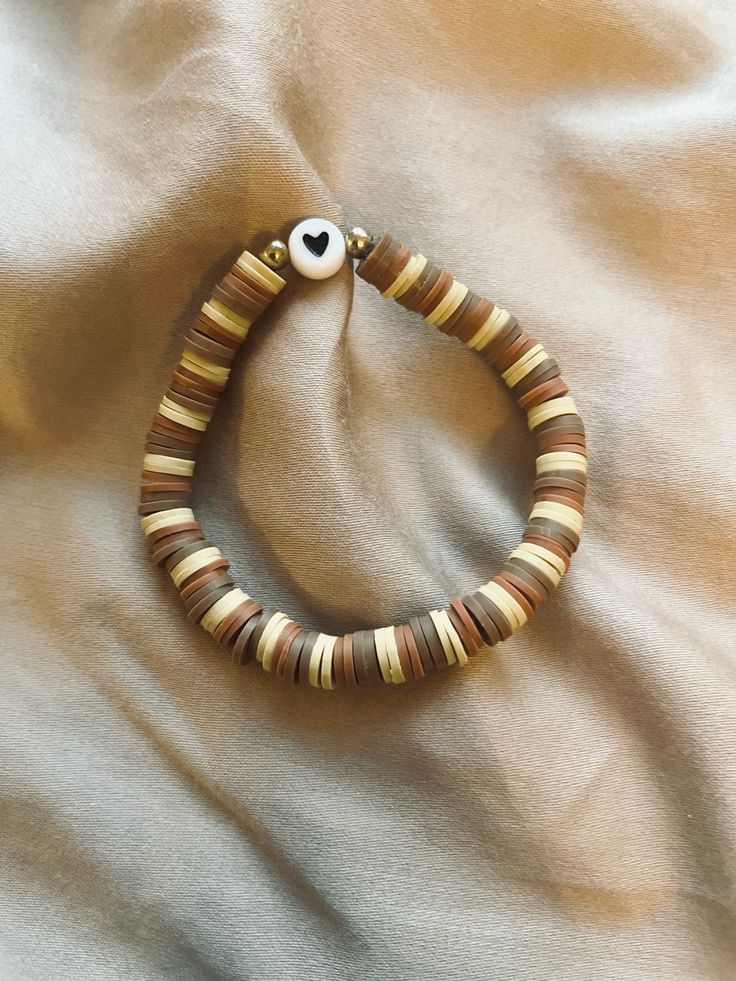 a bracelet with an eye on it laying on a bed