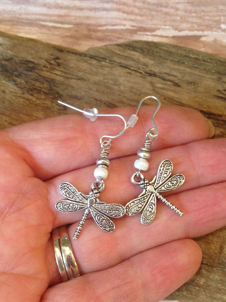 These gorgeous Boho Style Dragonfly Earrings are perfect for your summer wardrobe! So pretty with colors of cream and silver made with cream Czech seed beads, silver Tibetan beads and beautiful, detailed Silver Dragonfly charms! * I can switch out the cream beads for any color-just ask and I will be happy to do so.* The earring wires are lead free and will come with rubber backs. Beautiful gift idea which will come on a pretty gift box and organza bag! I have the complete jewelry set available f Bohemian Silver Butterfly Earrings, Bohemian Adjustable Butterfly Earrings, Bohemian Butterfly Nickel-free Jewelry, Dragonfly Charm, Dragonfly Earrings, Earring Wires, Bohemian Earrings, Pretty Gift, I Will Be Happy