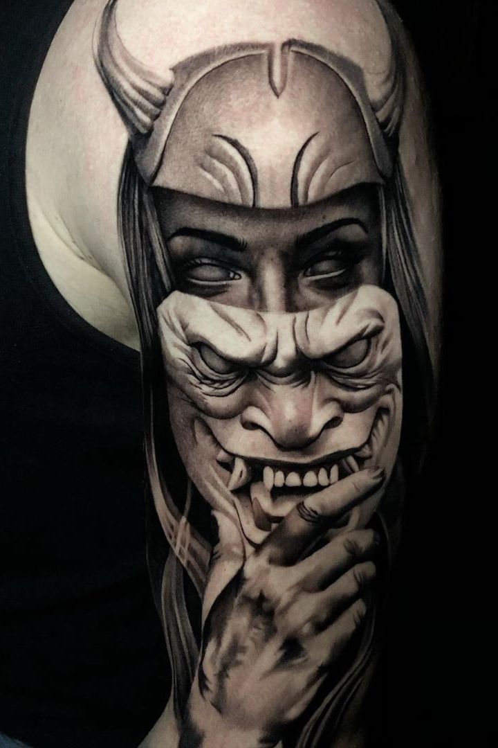 a woman with an evil face and horns on her arm