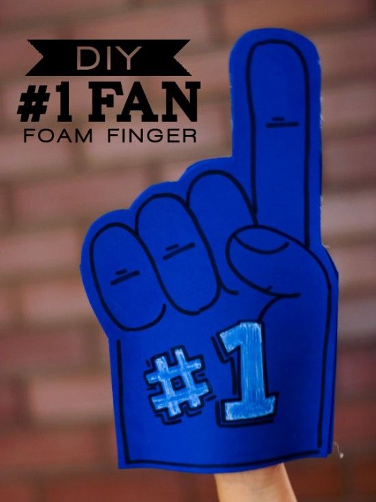 a hand holding up a foam finger sign with the number 1 on it's fingers