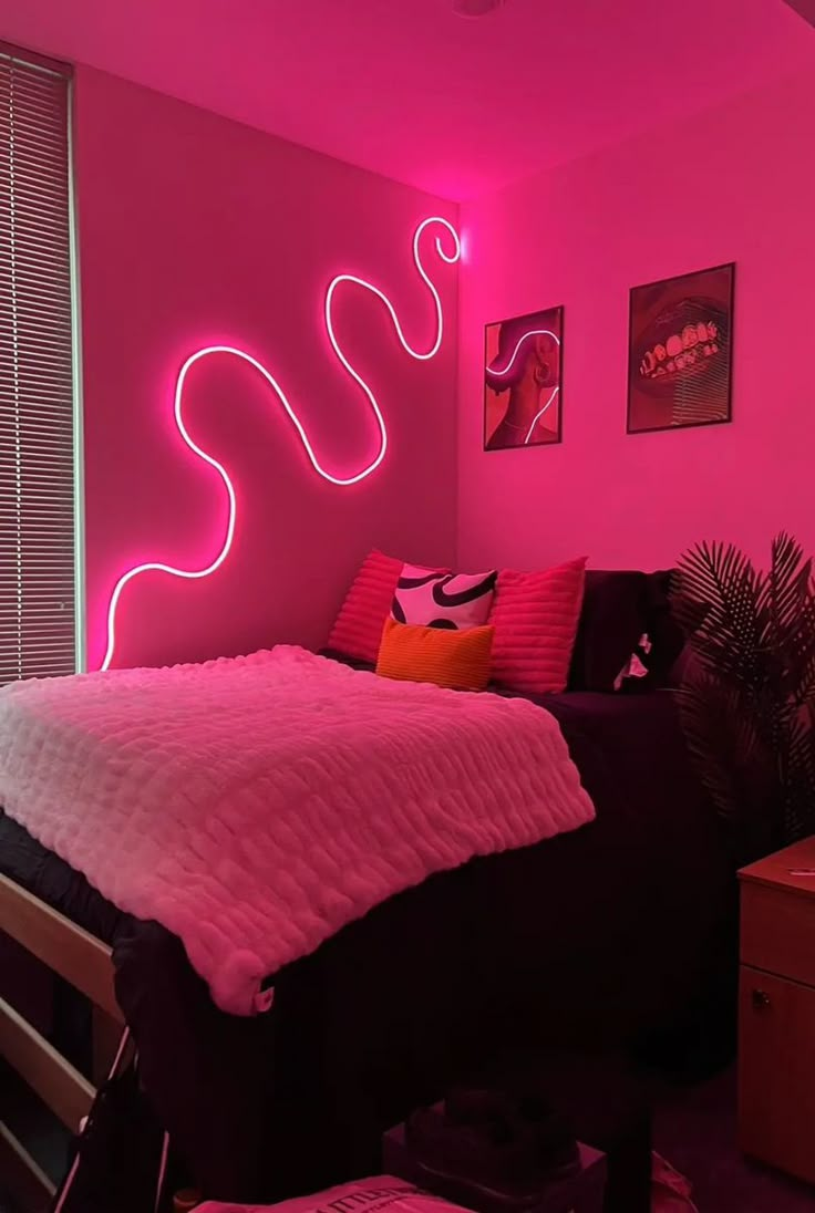 a bedroom with pink walls and neon lights on the wall, along with a bed