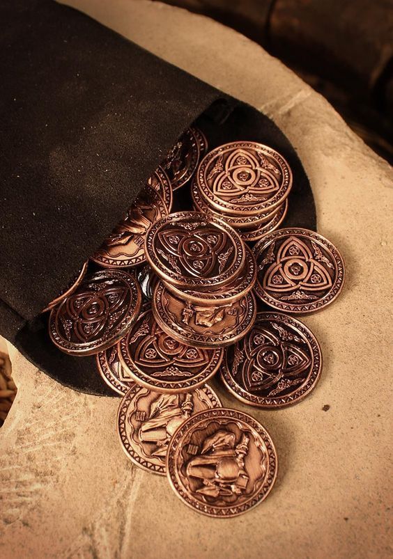 a pile of coins sitting on top of a black hat