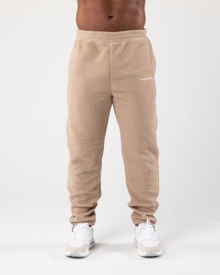 HIGHLIGHTS. Unisex fit with relaxed leg cut. Textured and plush fleece fabric Thick waistband with flat drawstrings from the inside Two spacious slip pockets Alphalete Core logo embroidered on upper left thigh. Elasticated cord adjustable ankle cuffs FIT SUGGESTION. This item runs true to Alphalete’s relaxed. fit.. If you are between sizes, we recommend sizing up. Male model is 6’0”/183cm, wearing a size XL with a 35”/89cm waist.. Female model is 5'7"/170cm, wearing a size S with a 29"/74cm wais Lounge Looks, Ankle Cuffs, Sporty Look, Logo Embroidered, Fleece Fabric, Male Model, Relaxed Fit, How To Wear