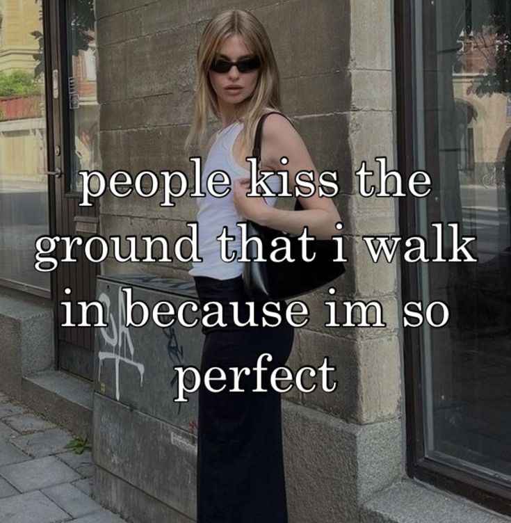 a woman standing in front of a building with the words people kiss the ground that i walk in because imso perfect