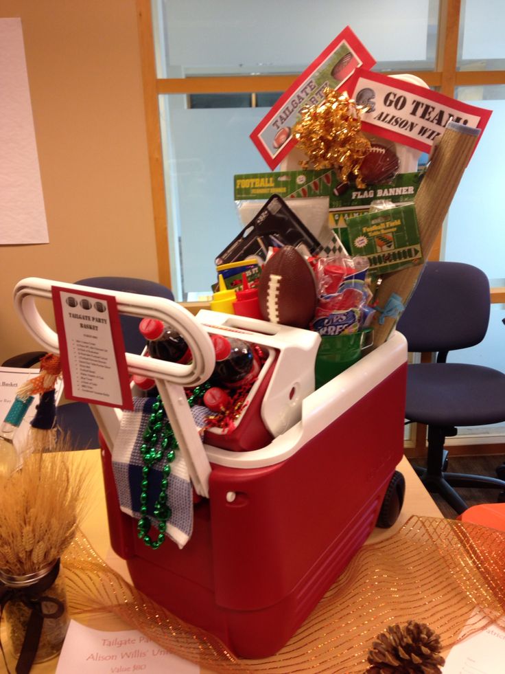 a red cooler filled with christmas items on top of a table