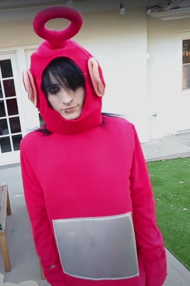 a person in a pink costume with a laptop on their chest and headphones attached to his ears