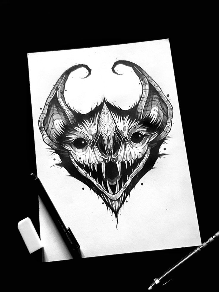 a drawing of a demon with horns and fangs on it's face is shown