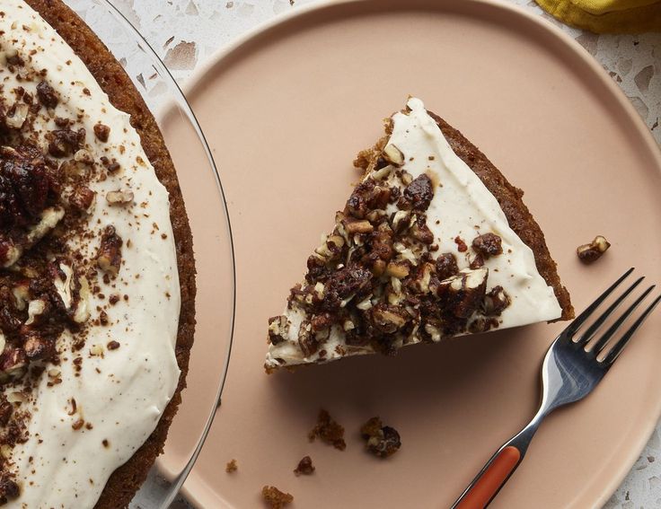 a piece of cake sitting on top of a pink plate next to a knife and fork