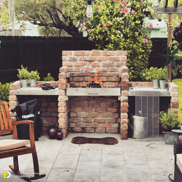 a brick oven sitting in the middle of a patio next to a chair and table