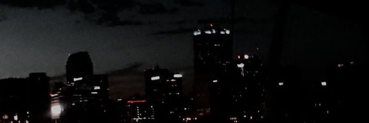 the city skyline is lit up at night